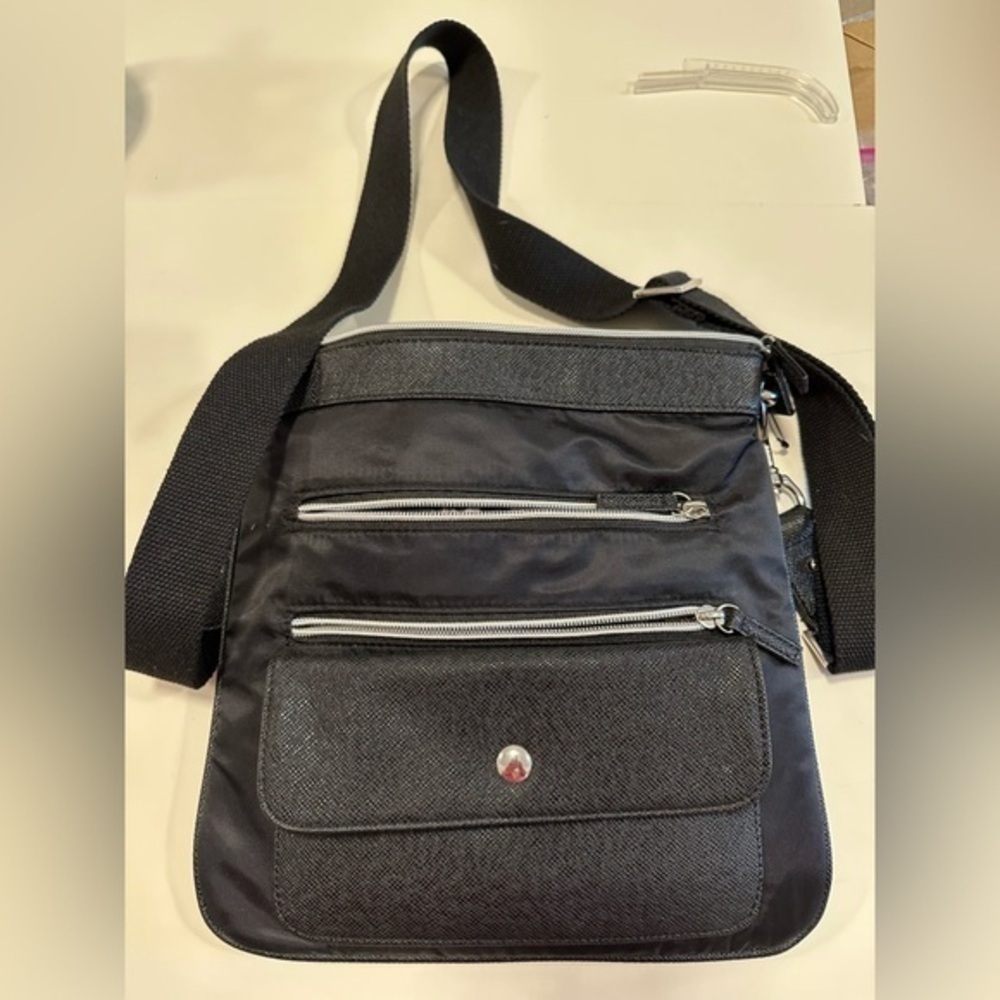 Chico’s cross body purse with long strap, lots of zippered pockets , black
